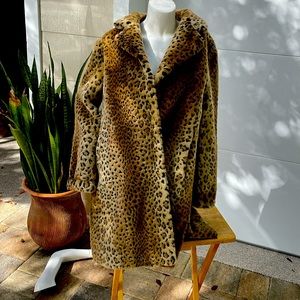 Faux fur car coat in animal print . Super soft and fully lined for warmth .